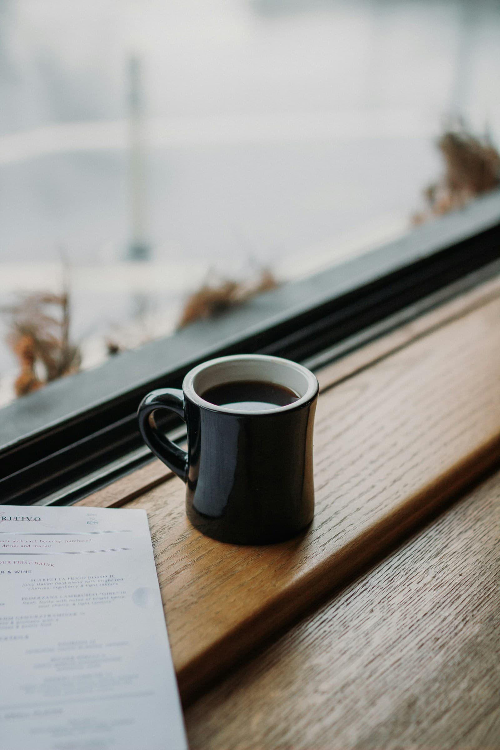 A cup of coffee on a softly lit café table